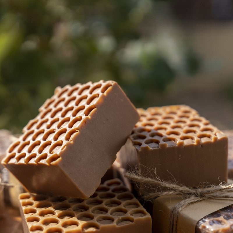 Handmade Beehive Black Chocolate & Honey Soap bars with a honeycomb design, ideal for moisturizing and balancing oily skin.